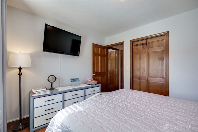 717 Walden Way, Dayton, OH 45440 - bedroom featuring a closet, baseboards, and wood finished floors