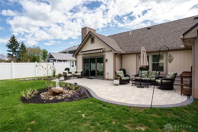 717 Walden Way, Dayton, OH 45440 - back of property with a patio area, roof with shingles, fence, and an outdoor living space