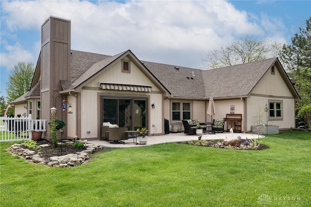 717 Walden Way, Dayton, OH 45440 - back of house featuring a chimney, a patio area, roof with shingles, and a yard