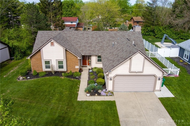 717 Walden Way, Dayton, OH 45440 - view of front of home with driveway, brick siding, a garage, roof with shingles, and a front lawn