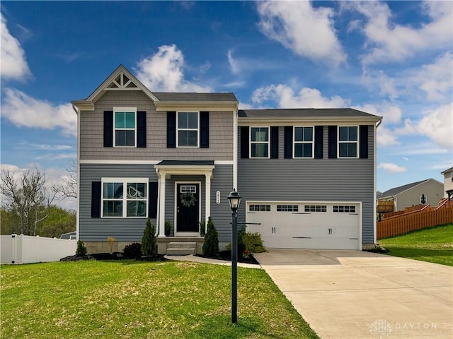 craftsman-style home with a garage, a front lawn, fence, and concrete driveway