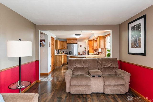 living area with baseboards and dark wood-style floors
