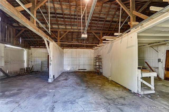 miscellaneous room with a garage and unfinished concrete flooring