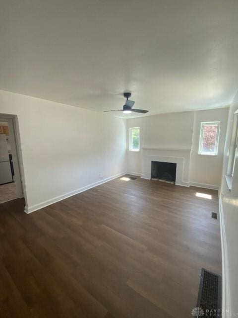 944 Wilmington Ave, Dayton, OH 45420 - unfurnished living room featuring dark wood-style floors, baseboards, a fireplace, and ceiling fan