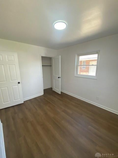 944 Wilmington Ave, Dayton, OH 45420 - unfurnished bedroom featuring baseboards, dark wood-style flooring, and a closet