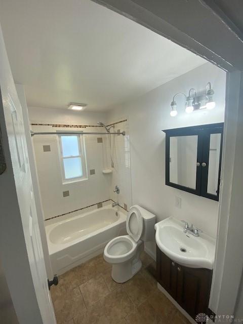 944 Wilmington Ave, Dayton, OH 45420 - bathroom with bathtub / shower combination, toilet, vanity, and tile patterned floors