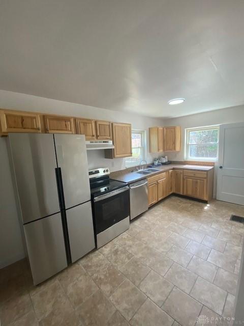 944 Wilmington Ave, Dayton, OH 45420 - kitchen with appliances with stainless steel finishes, a sink, under cabinet range hood, and light countertops