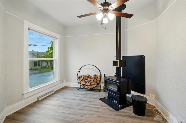 131 Hamilton St, West Milton, OH 45383 - living room with a wood stove, light wood-style floors, and ceiling fan