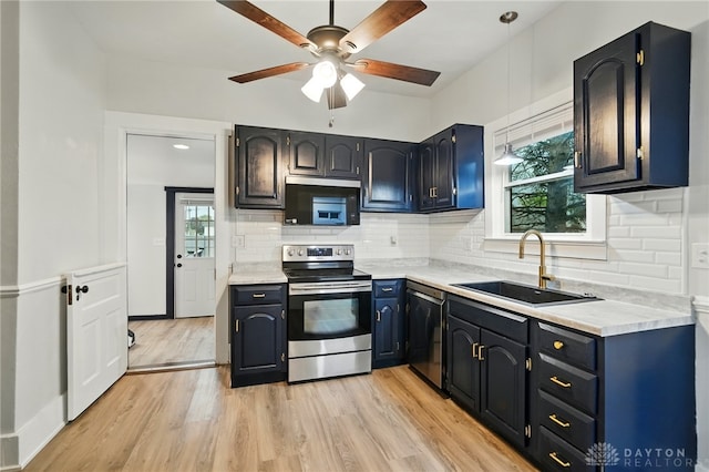 131 Hamilton St, West Milton, OH 45383 - kitchen featuring appliances with stainless steel finishes, a ceiling fan, light countertops, and light wood-type flooring