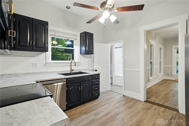 131 Hamilton St, West Milton, OH 45383 - kitchen with stainless steel dishwasher, light countertops, backsplash, and ceiling fan