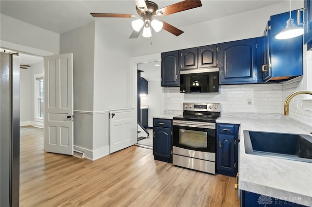 131 Hamilton St, West Milton, OH 45383 - kitchen with appliances with stainless steel finishes, blue cabinets, light wood-style flooring, and light countertops