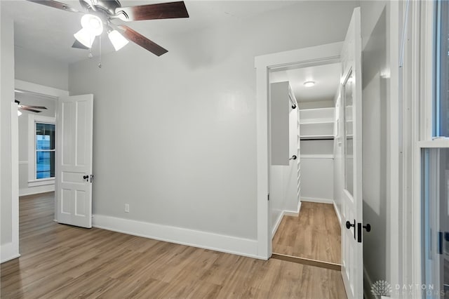 131 Hamilton St, West Milton, OH 45383 - unfurnished bedroom featuring light wood-style floors, a walk in closet, ceiling fan, and a closet