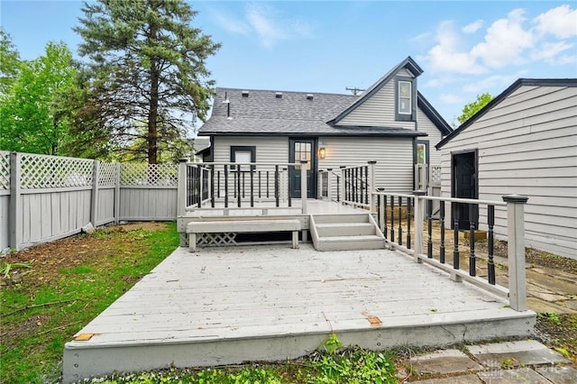 131 Hamilton St, West Milton, OH 45383 - back of property with a fenced backyard, a deck, and a shingled roof