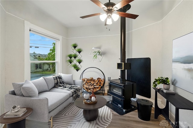 131 Hamilton St, West Milton, OH 45383 - living room with a wood stove, wood finished floors, and ceiling fan