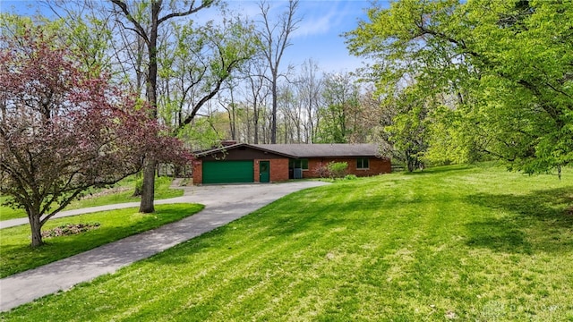 view of front facade with an attached garage, a front lawn, aphalt driveway, and brick siding