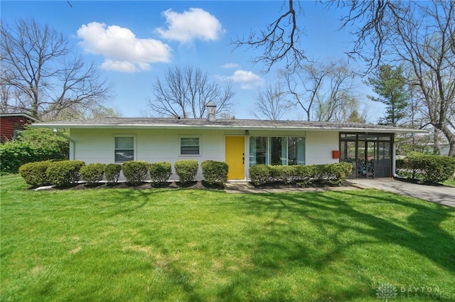 view of front of property with a front lawn and a chimney