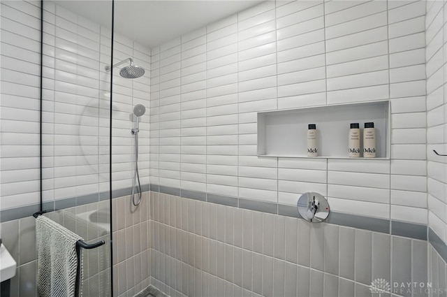 full bath featuring a tile shower