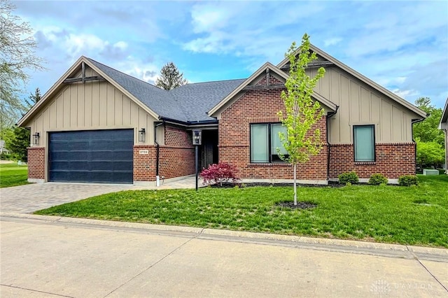 2725 Terraceview Cir, Beavercreek, OH 45431 - view of front facade with board and batten siding, an attached garage, decorative driveway, a front yard, and brick siding
