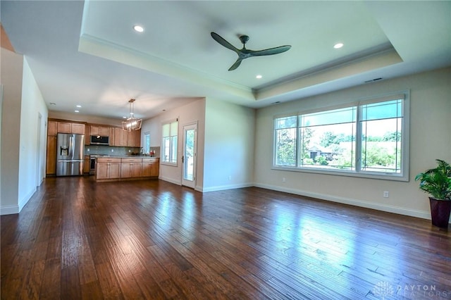 2725 Terraceview Cir, Beavercreek, OH 45431 - unfurnished living room with a tray ceiling, dark wood-type flooring, ceiling fan, recessed lighting, and crown molding