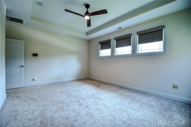 2725 Terraceview Cir, Beavercreek, OH 45431 - empty room featuring a raised ceiling, ceiling fan, plenty of natural light, and carpet