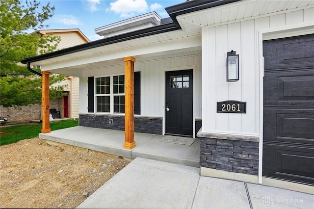 2061 Pine Forest Dr, Miamisburg, OH 45342 - entrance to property with a porch, board and batten siding, and stone siding