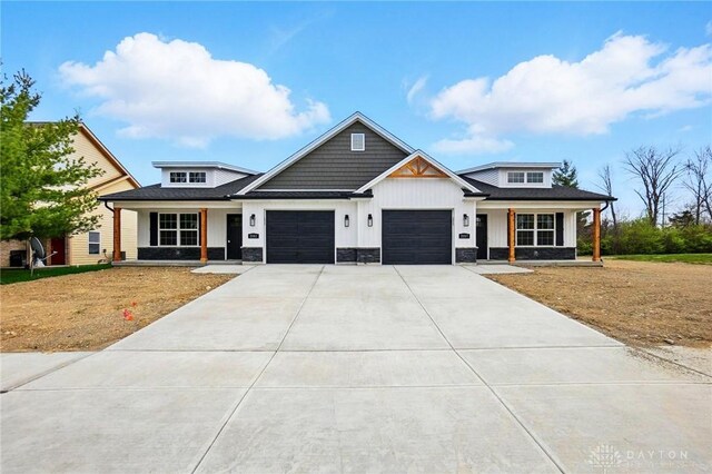 2061 Pine Forest Dr, Miamisburg, OH 45342 - modern farmhouse style home featuring a garage, a front lawn, covered porch, board and batten siding, and concrete driveway