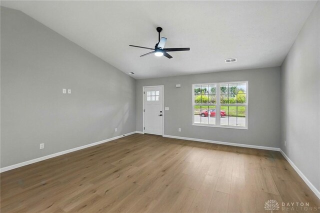 2061 Pine Forest Dr, Miamisburg, OH 45342 - unfurnished living room featuring visible vents, wood finished floors, lofted ceiling, baseboards, and ceiling fan