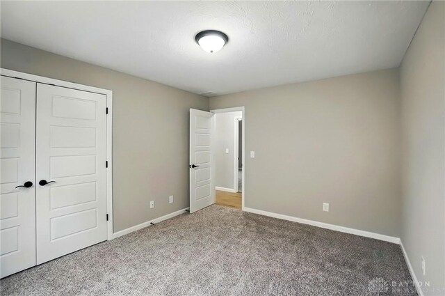 2061 Pine Forest Dr, Miamisburg, OH 45342 - unfurnished bedroom with a closet, baseboards, and carpet flooring
