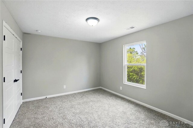 2061 Pine Forest Dr, Miamisburg, OH 45342 - unfurnished room with a textured ceiling, baseboards, visible vents, and carpet