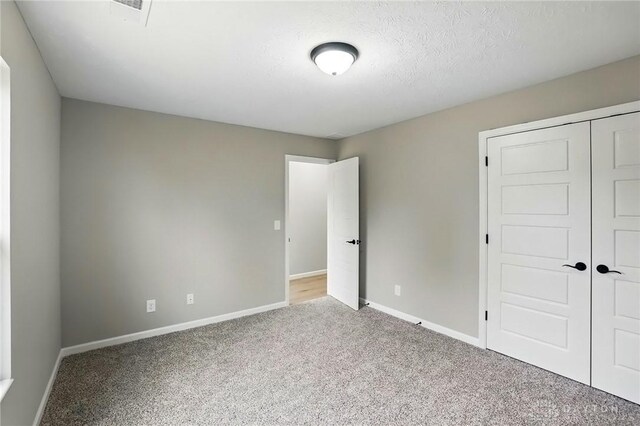 2061 Pine Forest Dr, Miamisburg, OH 45342 - unfurnished bedroom with carpet floors, baseboards, visible vents, and a closet