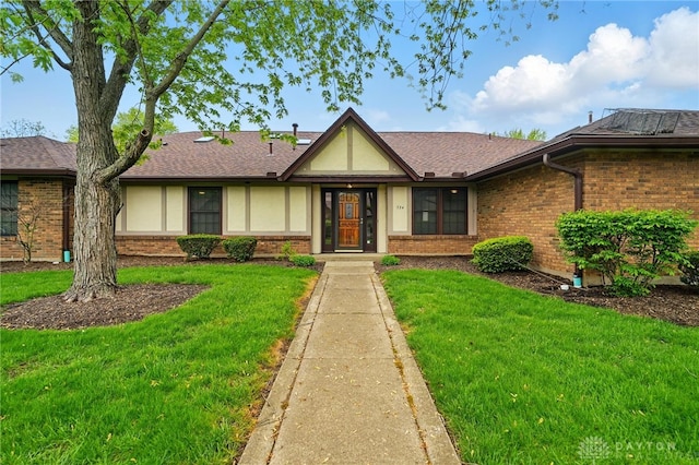 ranch-style house featuring brick siding and a front lawn