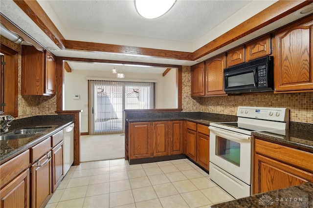 734 Pine Needles Dr, Washington Twp, OH 45458 - kitchen featuring a sink, dark stone counters, brown cabinets, and white appliances
