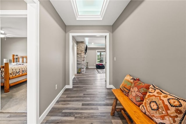 838 W Bentley Cir, Troy, OH 45373 - corridor featuring baseboards, wood finished floors, and a skylight