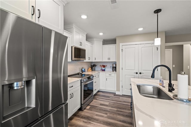 838 W Bentley Cir, Troy, OH 45373 - kitchen featuring white cabinets, decorative light fixtures, appliances with stainless steel finishes, and a sink