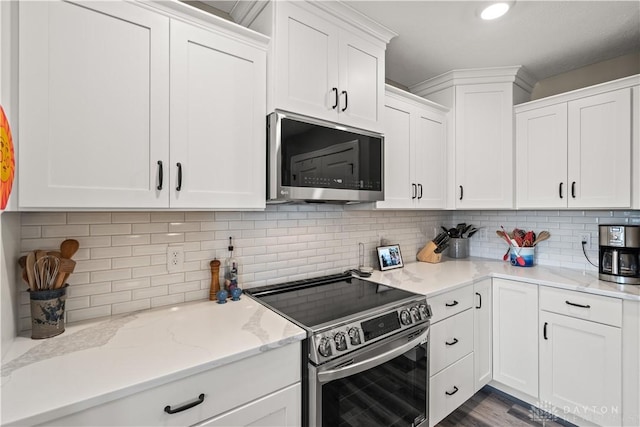838 W Bentley Cir, Troy, OH 45373 - kitchen featuring white cabinets, light stone countertops, appliances with stainless steel finishes, and decorative backsplash