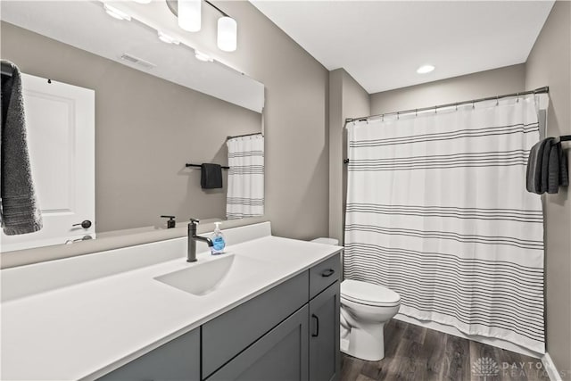 838 W Bentley Cir, Troy, OH 45373 - bathroom featuring visible vents, vanity, wood finished floors, toilet, and recessed lighting