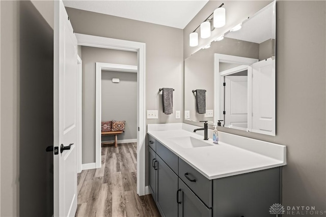 838 W Bentley Cir, Troy, OH 45373 - bathroom featuring vanity, baseboards, and wood finished floors