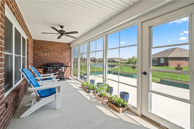 838 W Bentley Cir, Troy, OH 45373 - unfurnished sunroom with a water view, a ceiling fan, and plenty of natural light