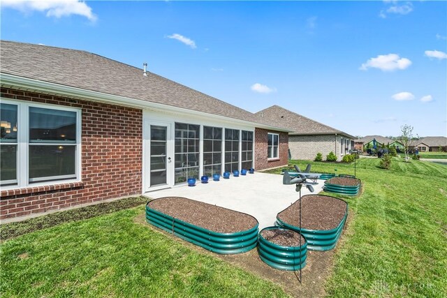 838 W Bentley Cir, Troy, OH 45373 - rear view of property featuring a yard, a patio area, and brick siding