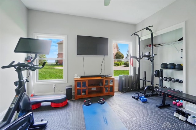 workout area featuring baseboards and a healthy amount of sunlight