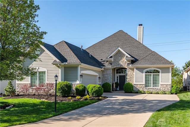 835 Vintage Green Way, Centerville, OH 45458 - french provincial home with stone siding, a chimney, a garage, and roof with shingles
