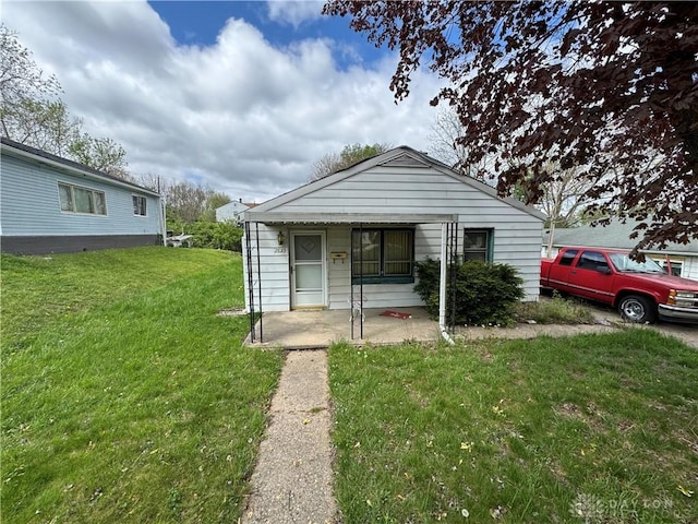 bungalow-style house with a front yard
