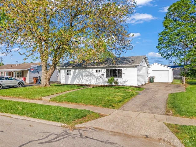 149 Poe Ln, Xenia, OH 45385 - view of front of house with a detached garage, an outbuilding, a front yard, and aphalt driveway