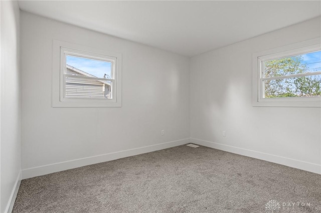 149 Poe Ln, Xenia, OH 45385 - carpeted empty room featuring baseboards and a wealth of natural light