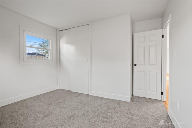 149 Poe Ln, Xenia, OH 45385 - unfurnished bedroom with carpet flooring, baseboards, and a closet