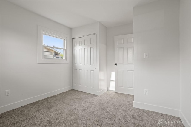 149 Poe Ln, Xenia, OH 45385 - unfurnished bedroom with baseboards, carpet, and a closet