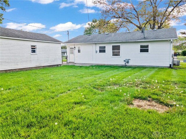 149 Poe Ln, Xenia, OH 45385 - back of house featuring a lawn