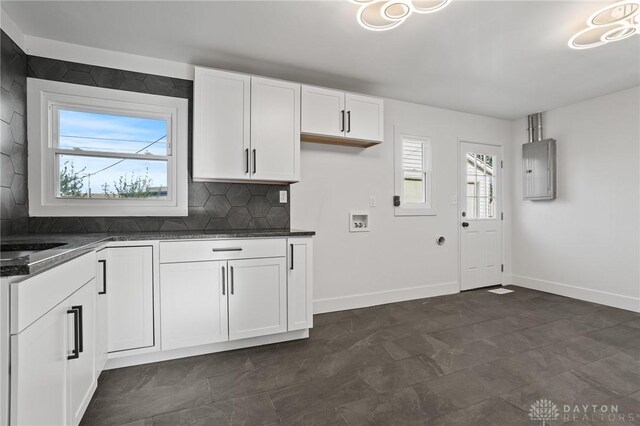 149 Poe Ln, Xenia, OH 45385 - kitchen with baseboards, white cabinetry, backsplash, and electric panel