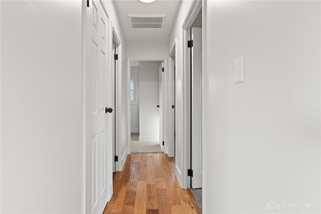 149 Poe Ln, Xenia, OH 45385 - hallway with baseboards, visible vents, and light wood-style flooring