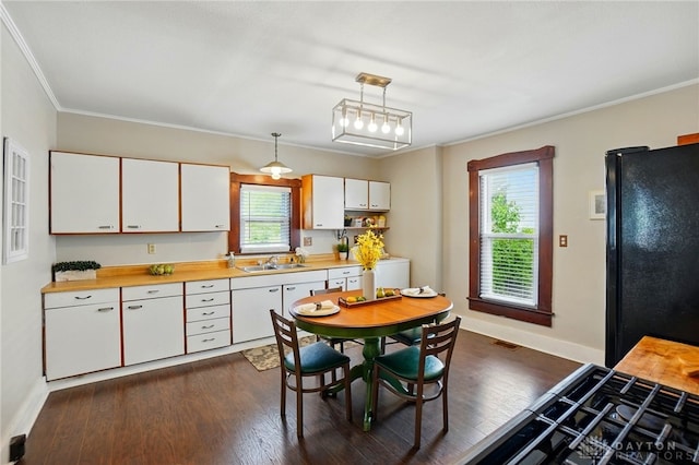 281 S Riverview Ave, Miamisburg, OH 45342 - kitchen featuring white cabinets, a sink, light countertops, freestanding refrigerator, and dark wood-type flooring